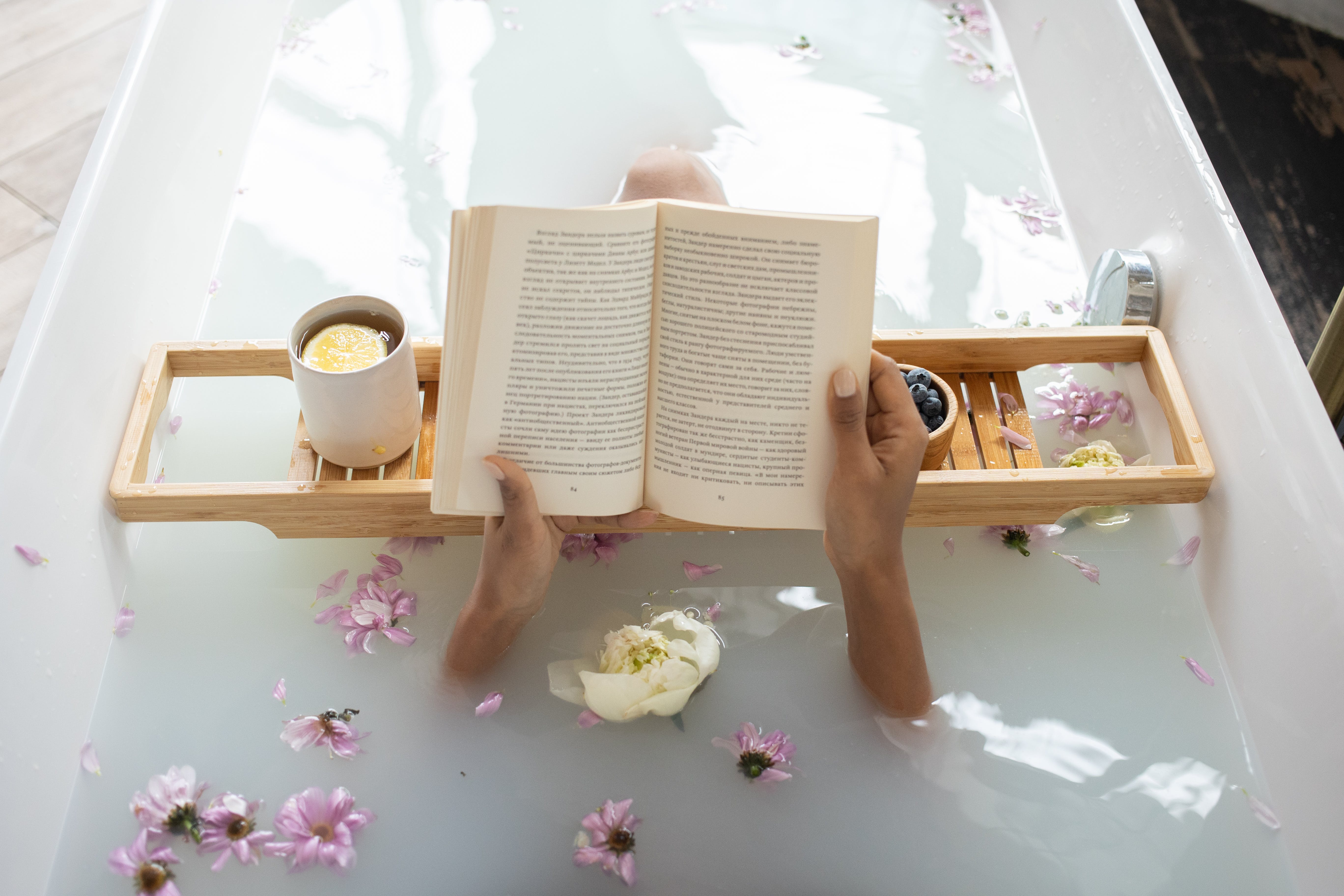 Lady reading book in the bath